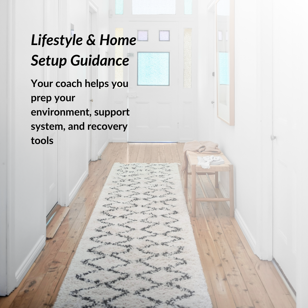 Long white rug with black pattern on wooden floor in a room with white walls and a small table.